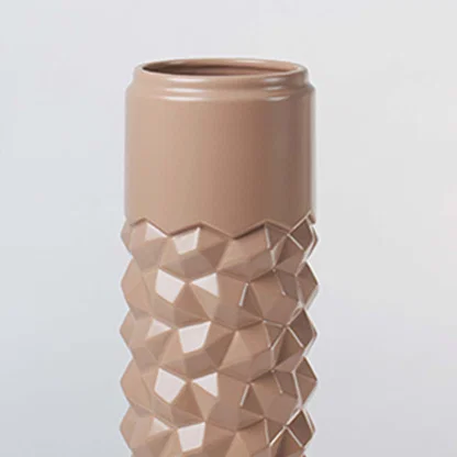 Close view of the tall beige ceramic vase showing its raised geometric texture and smooth glossy finish for a modern decor feel.