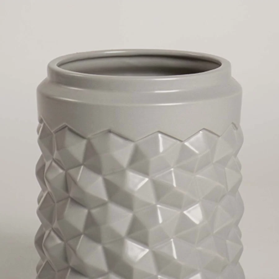 Detailed close view of the grey ceramic vase showing its raised geometric texture and smooth finish for a modern decorative appeal.