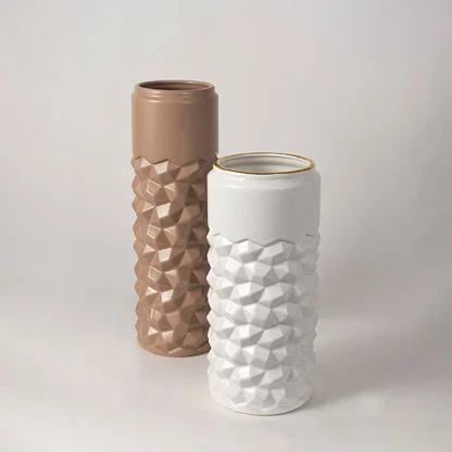 White geometric ceramic vase with gold rim arranged in a grouped decor setup highlighting its modern textured pattern for elegant interiors.