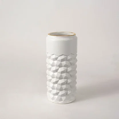 White ceramic decorative vase with raised bubble pattern and gold rim for elegant modern home decor styling.