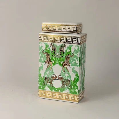 Side angle view of white ceramic jar showing gold trim and intricate hand-painted tiger design.