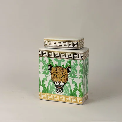 Side angle view of white ceramic jar showing gold-trimmed edges and detailed hand-painted leopard artwork.