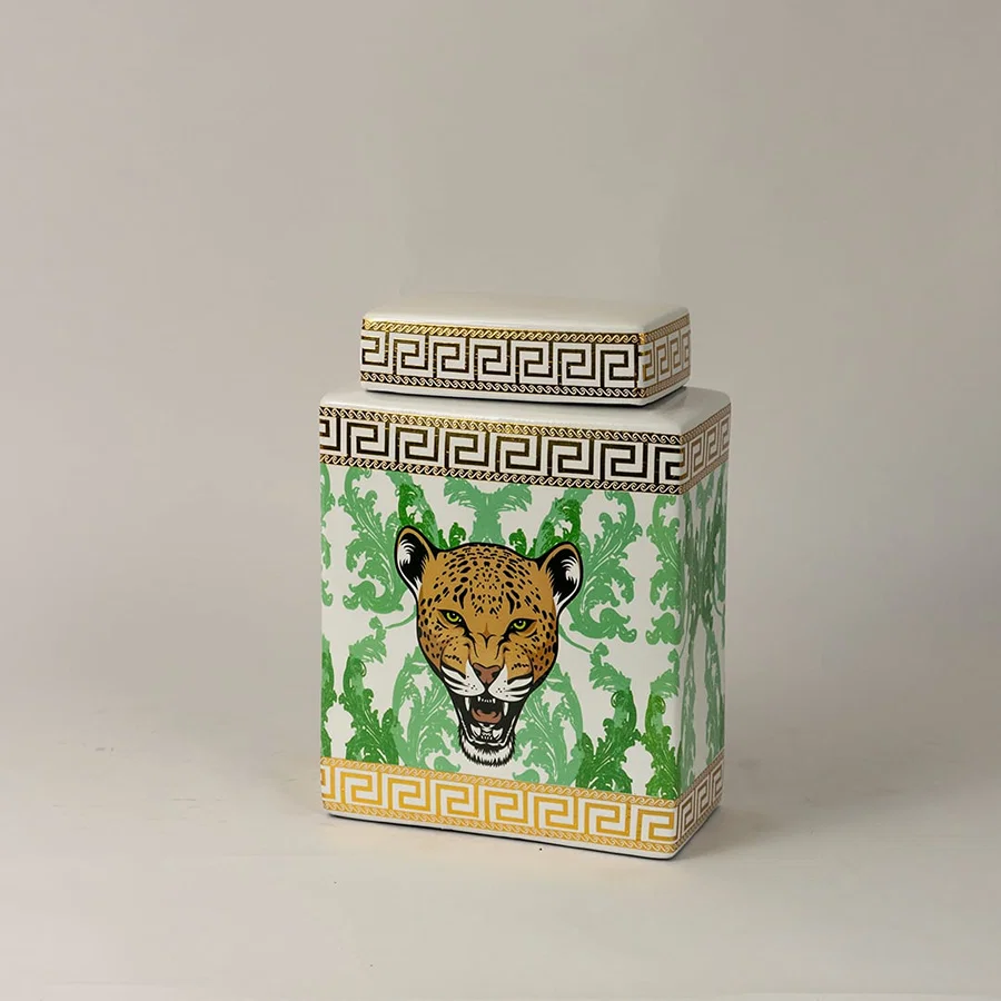 Side angle view of white ceramic jar showing gold-trimmed edges and detailed hand-painted leopard artwork.