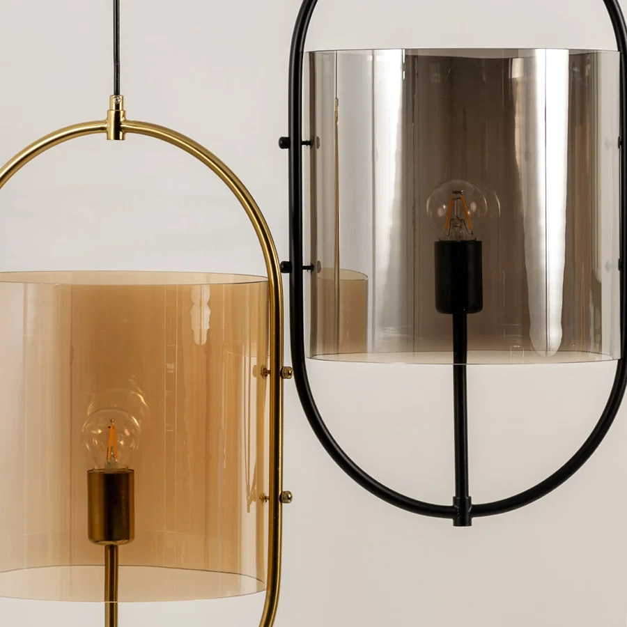 Amber and smoke glass wall lights closeup highlighting refined metal framework and premium lighting craftsmanship.