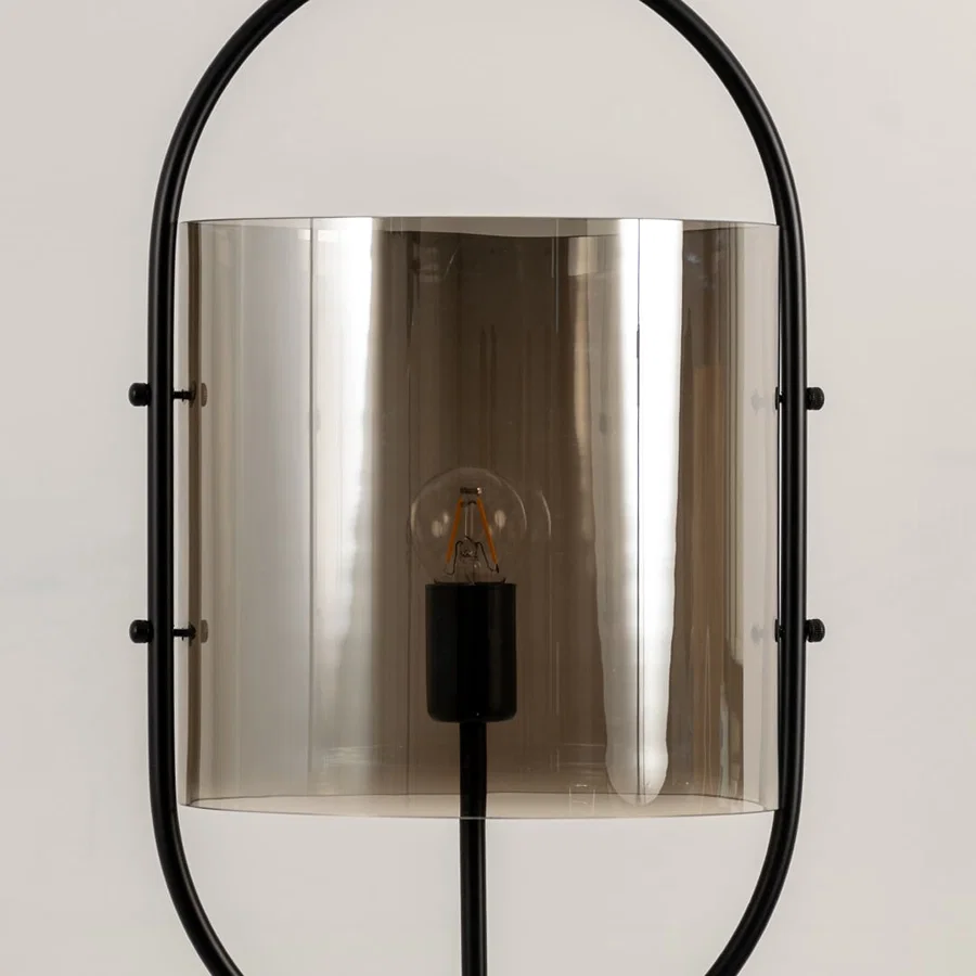 Smoke glass wall light closeup highlighting tinted glass finish and premium modern decorative lighting craftsmanship.