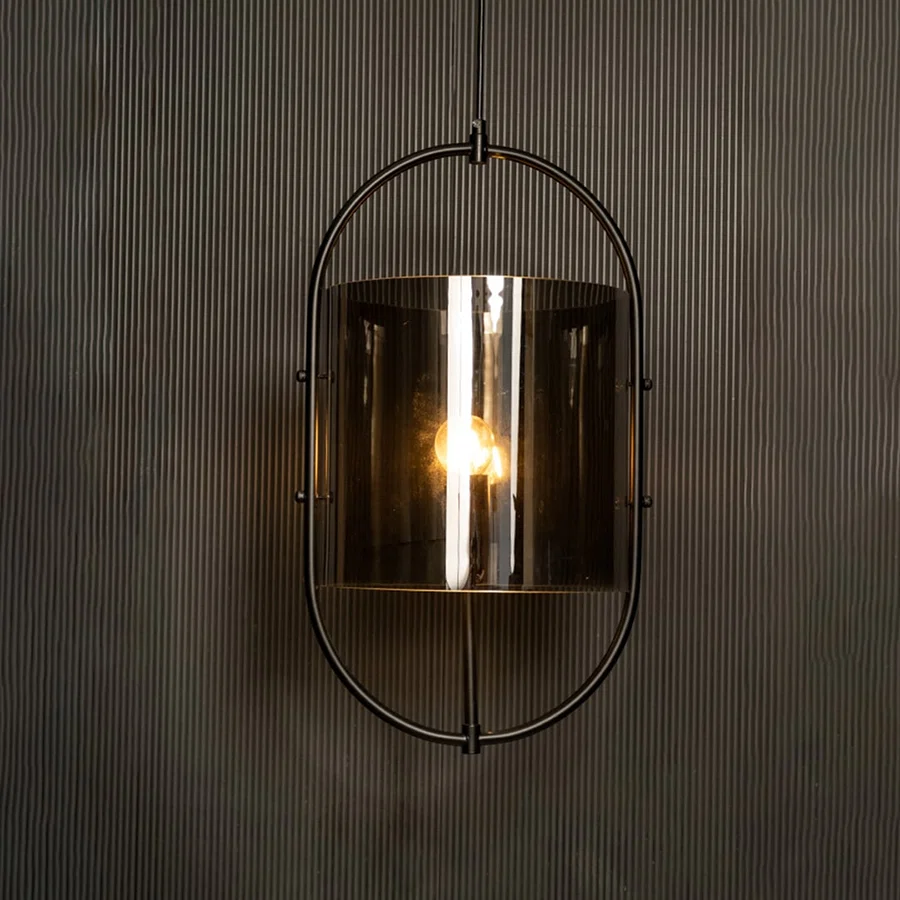 Illuminated pendant showcasing a striking contrast between the black metal frame and smoked glass against a dark backdrop.