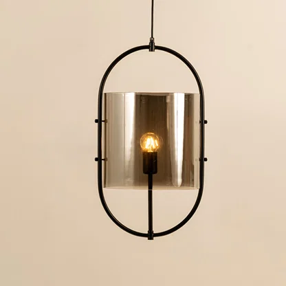 Modern black metal pendant light with smoked glass shade for elegant dining room and luxury decor styling.