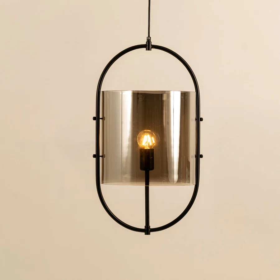 Modern black metal pendant light with smoked glass shade for elegant dining room and luxury decor styling.