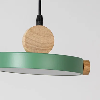 Green metal pendant light with natural wood accents showcasing clean lines and modern Scandinavian inspired design.