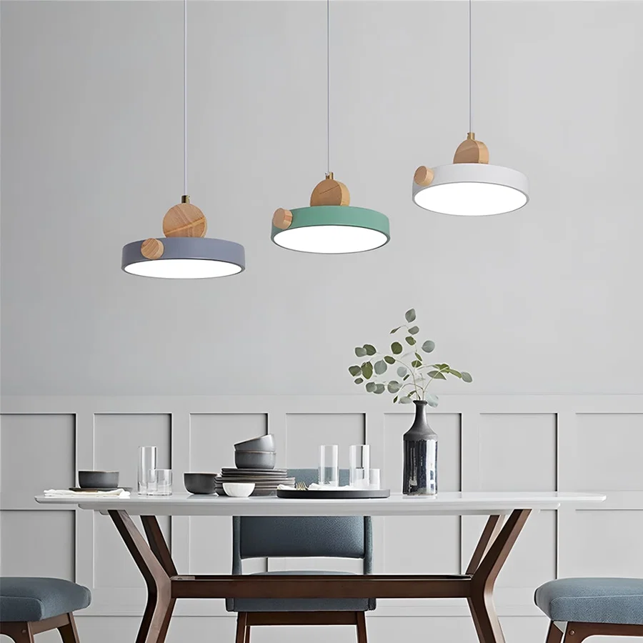 White metal pendant light above lounge seating adding warm ambient lighting and Scandinavian elegance to modern interiors.