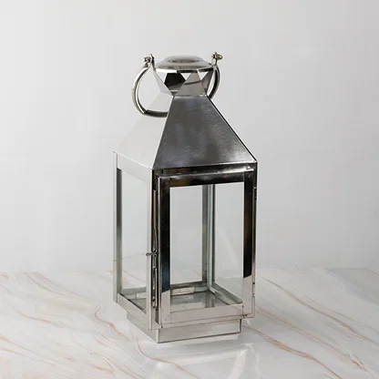 Stainless steel lantern turned off displayed plain on white background highlighting polished finish.
