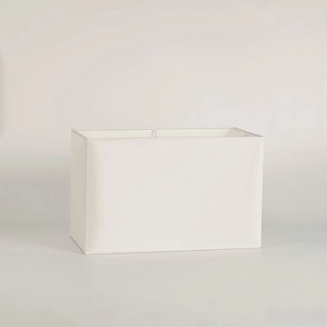 White rectangular lamp shade on plain background shown in close up view for modern minimal lighting décor.