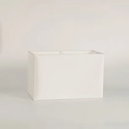 White rectangular lamp shade on plain background shown in close up view for modern minimal lighting décor.