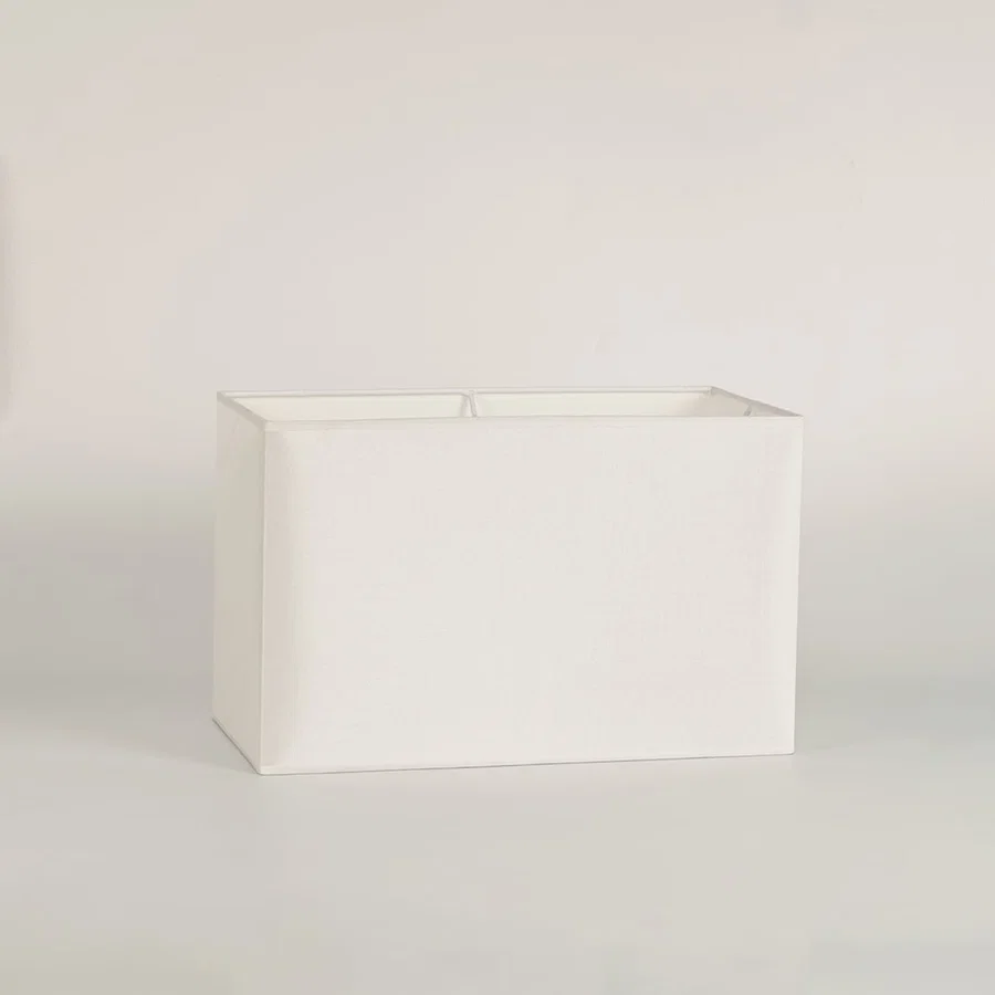 White rectangular lamp shade on plain background shown in close up view for modern minimal lighting décor.