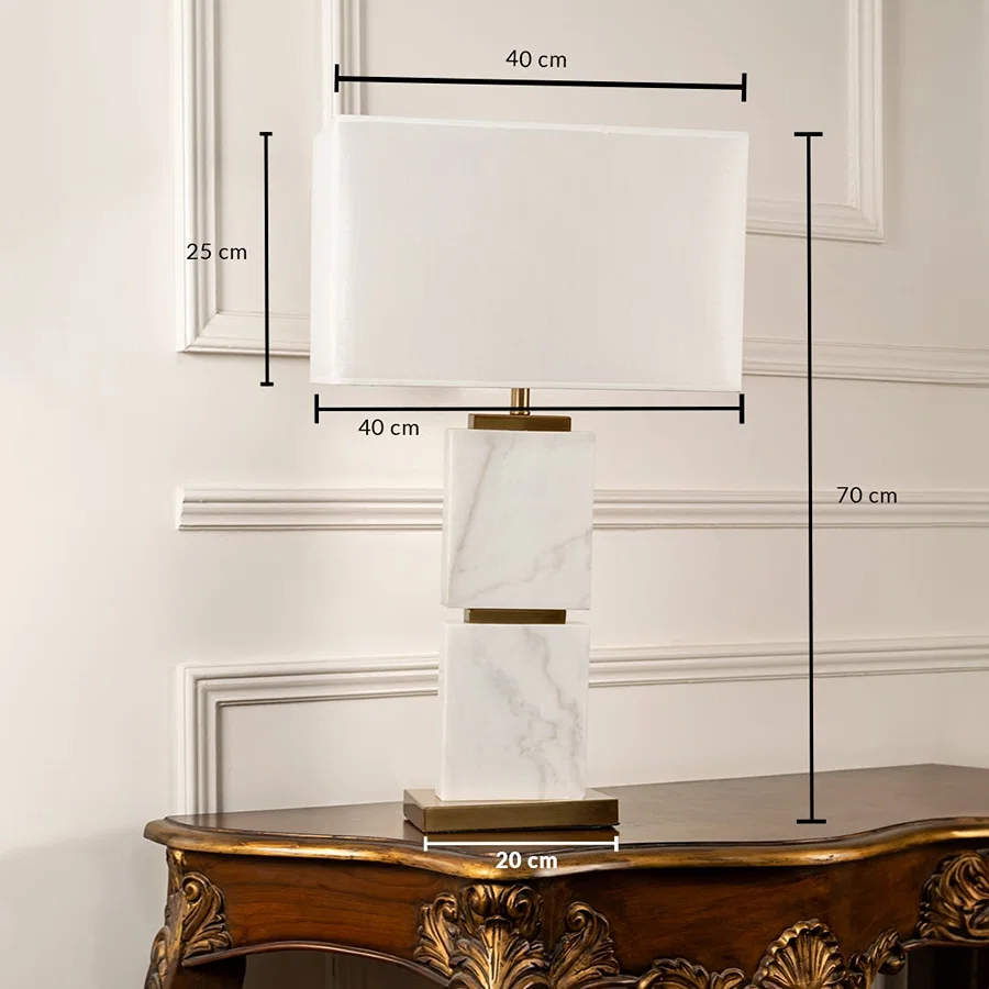 White rectangular shade marble block table lamp with size 60cm height and 33cm width on carved console table with light off for modern luxury décor.