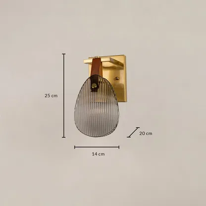 Gold wall light with ribbed glass shade measuring 14 cm width 25 cm height and 20 cm depth for accurate placement.