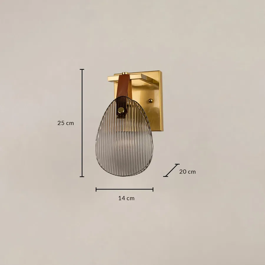 Gold wall light with ribbed glass shade measuring 14 cm width 25 cm height and 20 cm depth for accurate placement.