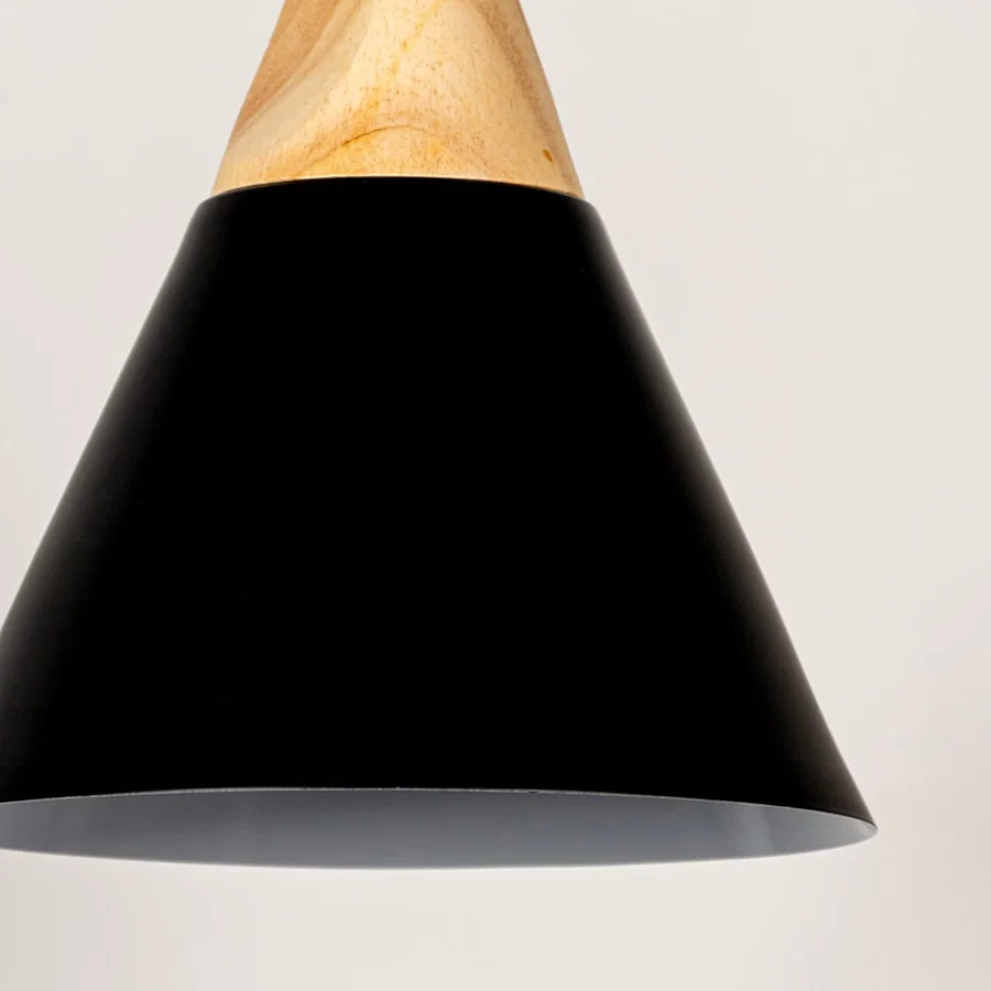 Black metal pendant light with natural wood accents showcasing wide cone shape and modern Scandinavian design appeal.