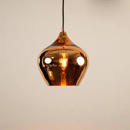 Copper glass pendant light illuminated to showcase luxury ceiling lighting with reflective finish and modern elegance.