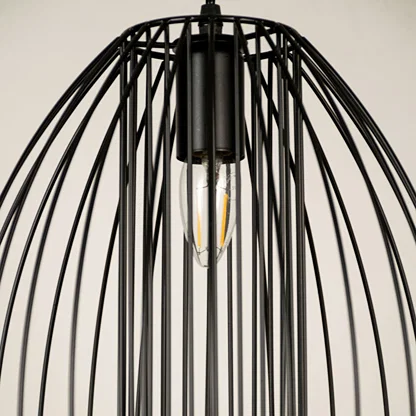 Black metal cage pendant light with exposed bulb detail showcasing durable metal craftsmanship and modern style.