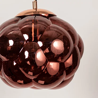 Copper glass pendant light featuring glossy sculpted glass texture and contemporary design for luxury interior decor.