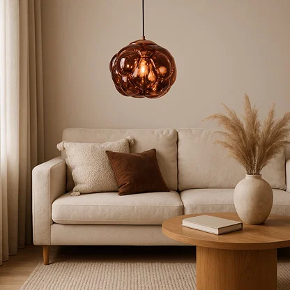 Copper glass pendant light above sofa adding warm ambient lighting and luxurious modern elegance to living room decor.