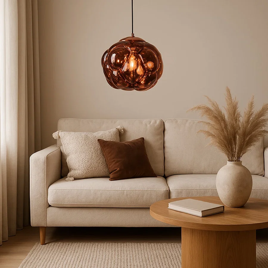 Copper glass pendant light above sofa adding warm ambient lighting and luxurious modern elegance to living room decor.