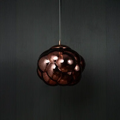 Brown glass bubble pendant light bulb off on black background featuring artistic round shade and modern design.