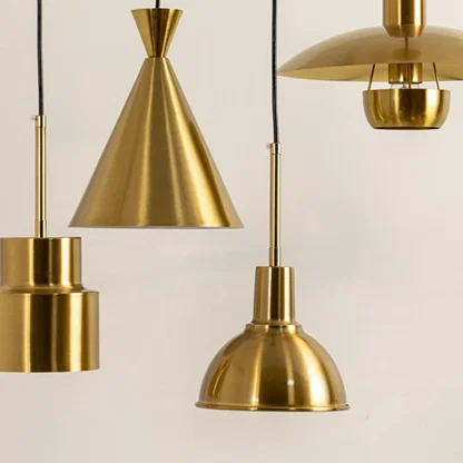 Gold metal pendant lights illuminated to showcase premium decorative ceiling lighting with contemporary design appeal.