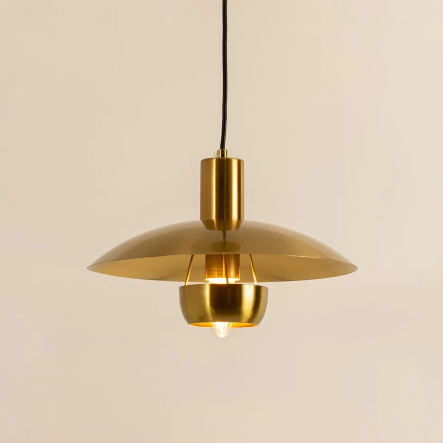 Gold metal pendant light with dome shade illuminated to showcase modern ceiling lighting and premium decorative appeal.