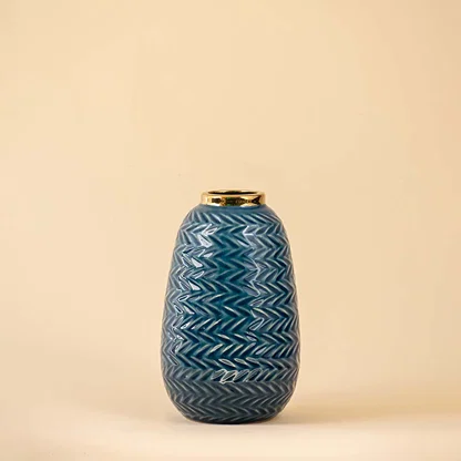 Blue ceramic decorative vase with embossed texture and gold accent for contemporary tabletop styling and decor.