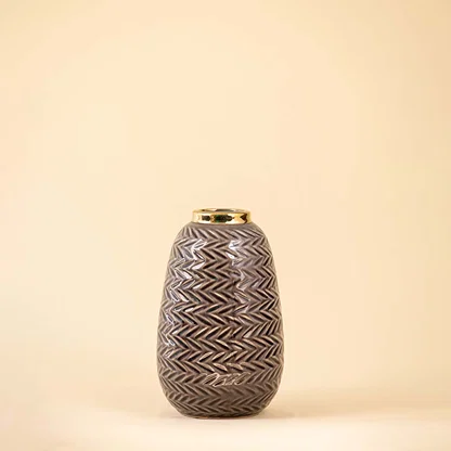 Grey ceramic decorative vase with textured geometric pattern and gold rim for elegant modern home decor styling.