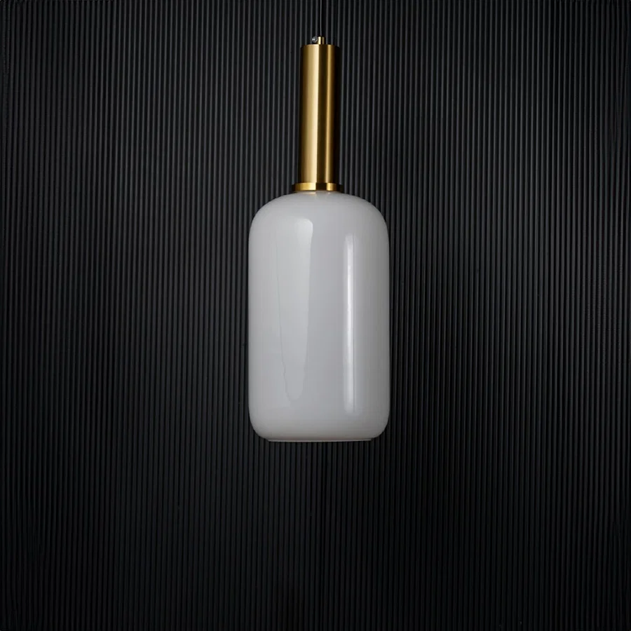 Modern white glass pendant light turned off with golden holder displayed elegantly on black background decor.