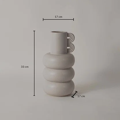 A sculptural neutral vase shown on a white background with clear dimension markings displaying 33 cm height 17 cm top width and 17 cm base width.