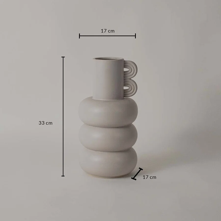 A sculptural neutral vase shown on a white background with clear dimension markings displaying 33 cm height 17 cm top width and 17 cm base width.