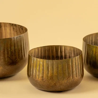 Bronze ribbed metal bowl planter closeup showing textured finish perfect for shelves tables and natural modern decor.