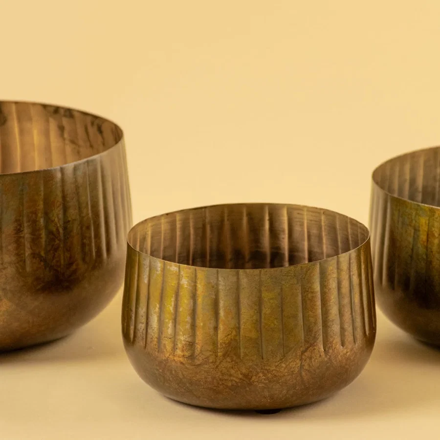 Bronze ribbed metal bowl planter closeup showing textured finish perfect for shelves tables and natural modern decor.