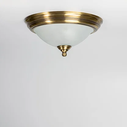 Modern antique brass ceiling light with frosted glass diffuser for stylish bedroom and traditional home decor spaces.
