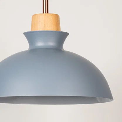 Blue metal pendant light with natural wood detailing showcasing smooth dome shape and modern Scandinavian design appeal.