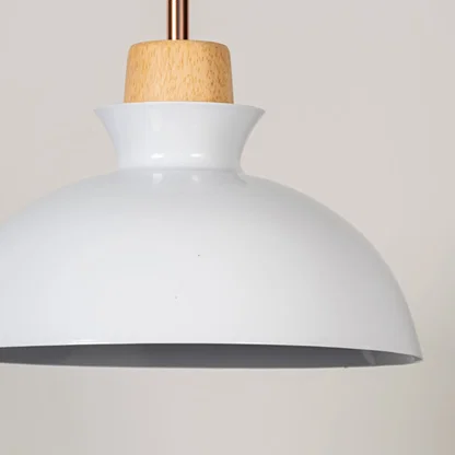 White metal pendant light with natural wood detailing showcasing smooth dome shape and modern Scandinavian design appeal.