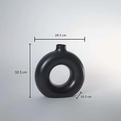 Black ceramic donut vase with matte finish measuring 32.5 cm height 28.5 cm width and 10.5 cm depth for elegant decor.