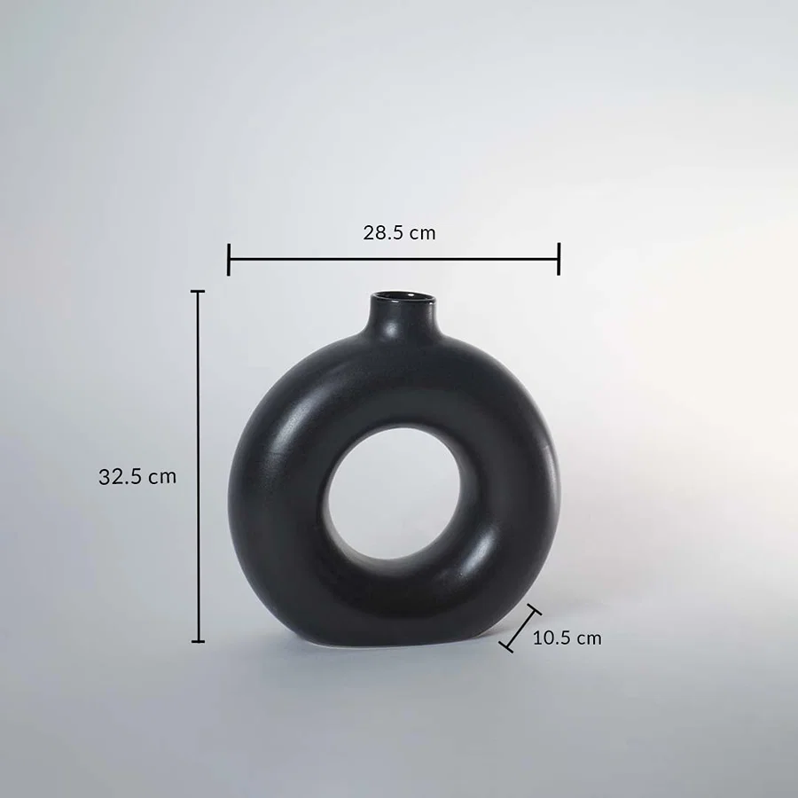 Black ceramic donut vase with matte finish measuring 32.5 cm height 28.5 cm width and 10.5 cm depth for elegant decor.