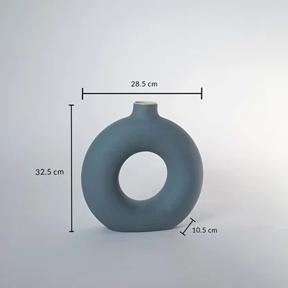 Green ceramic donut vase with matte finish measuring 32.5 cm height 28.5 cm width and 10.5 cm depth for stylish decor.