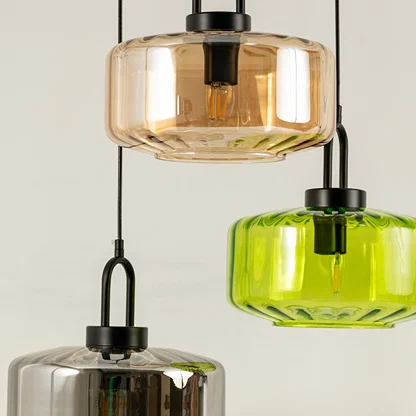 Amber and smoke glass pendant lights closeup showcasing layered glass detailing and luxury lighting craftsmanship.