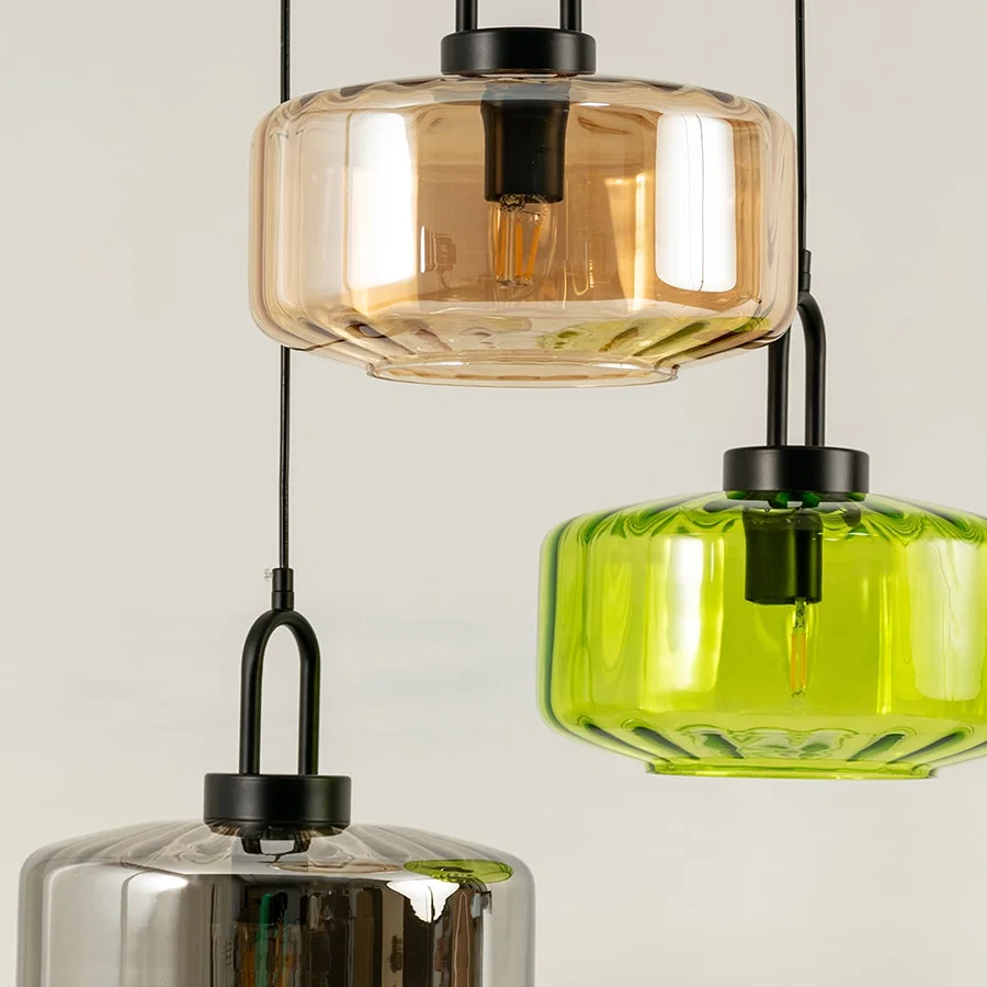 Amber and smoke glass pendant lights closeup showcasing layered glass detailing and luxury lighting craftsmanship.