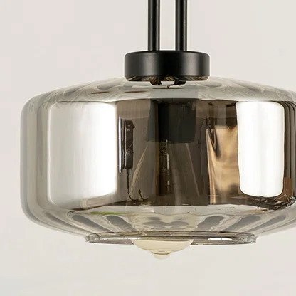 Smoke glass pendant light closeup highlighting tinted glass finish and premium contemporary lighting craftsmanship details.