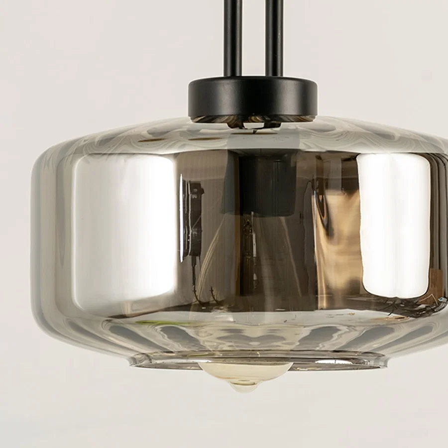 Smoke glass pendant light closeup highlighting tinted glass finish and premium contemporary lighting craftsmanship details.