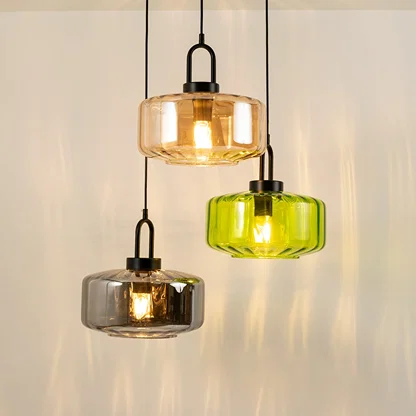 Amber smoke and green glass pendant lights creating vibrant ambient lighting in a modern interior setting.