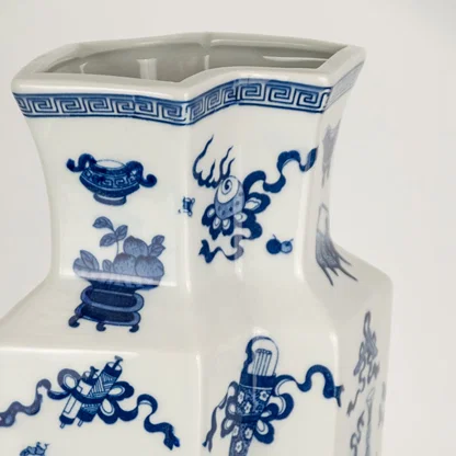 Closeup of blue and white ceramic decorative vase with floral artwork showcasing premium craftsmanship and elegant styling.