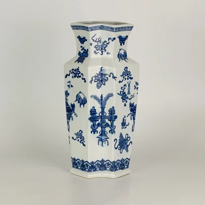 Blue and white ceramic vase with floral pattern design perfect for elegant table or shelf decor placement in modern home interior.